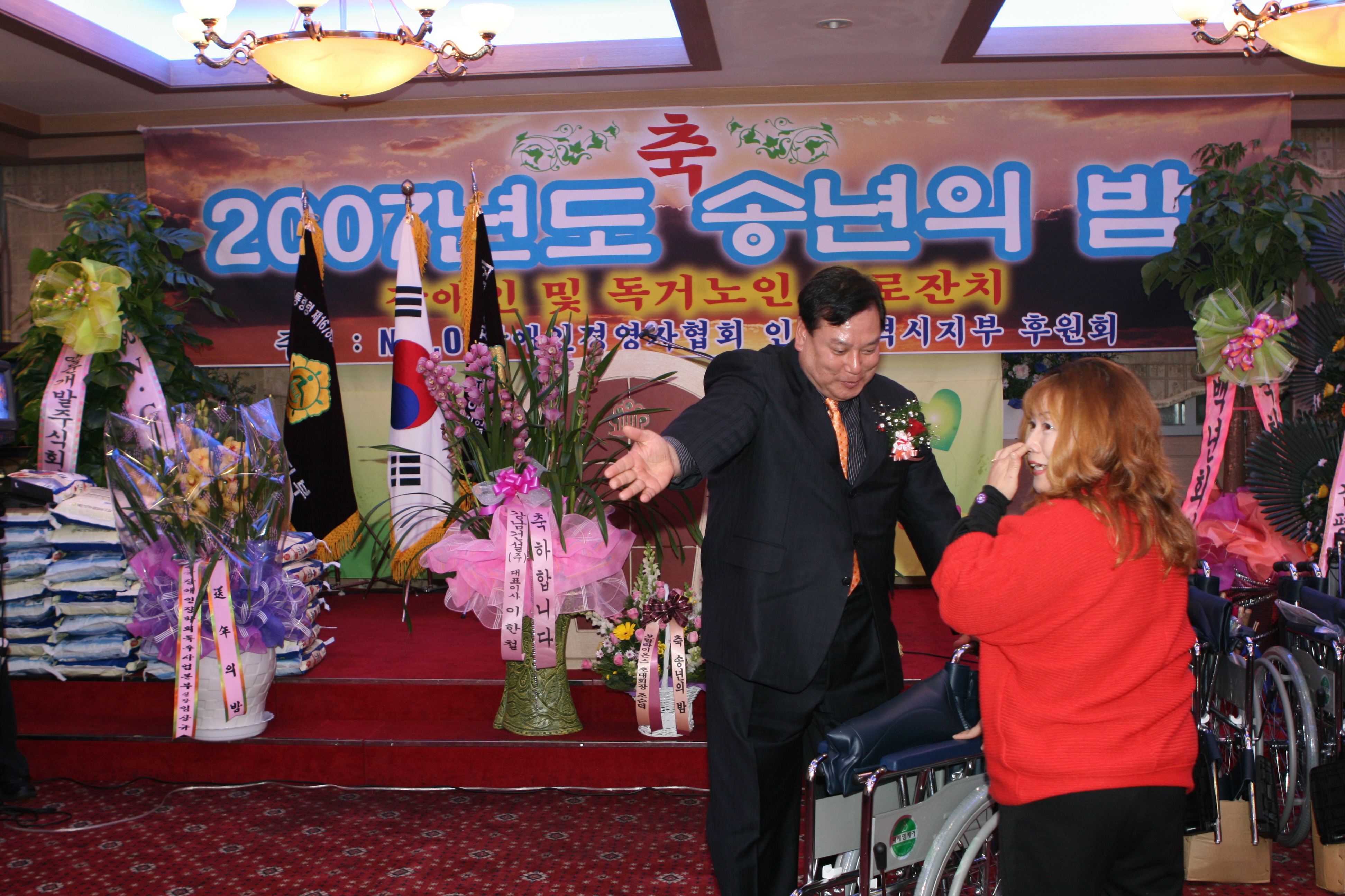 후원회에서 마련한 휠체어 5대를 어려운 장애인들에게 전달하고 있는 모습